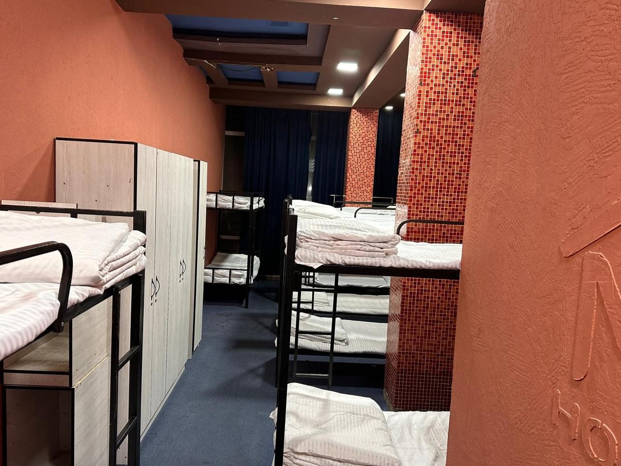 Shared dormitory with bunk beds and fresh linen