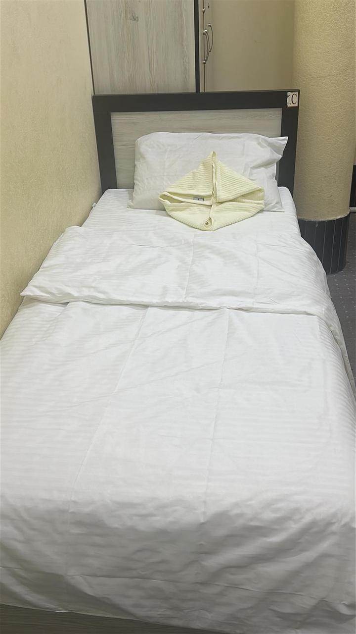 Single bed made up with a folded towel